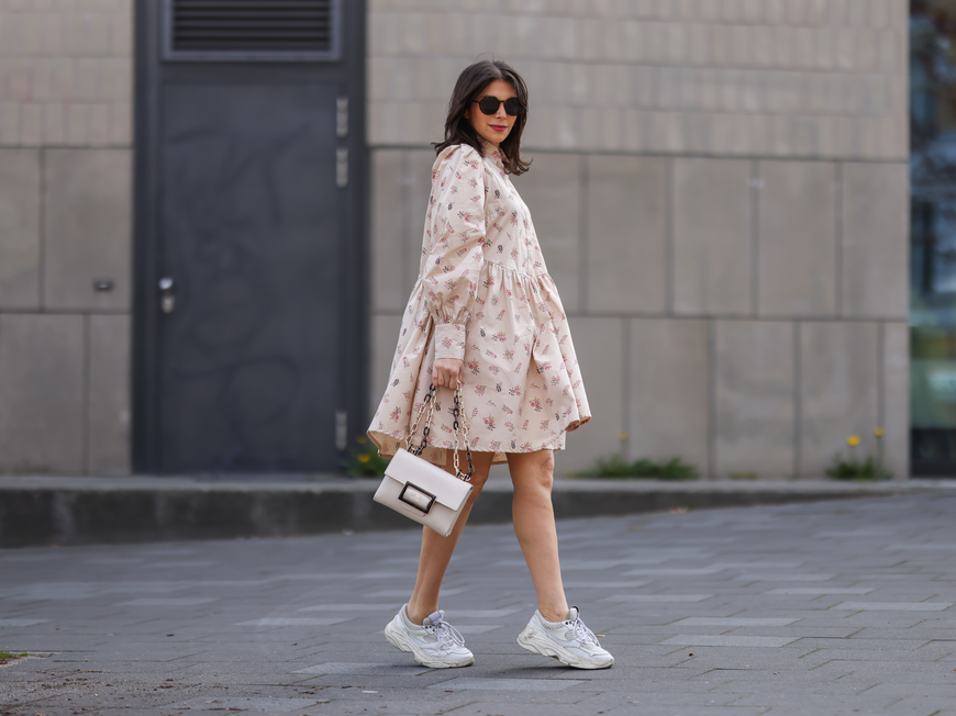 Frau in Kleid mit Sneaker