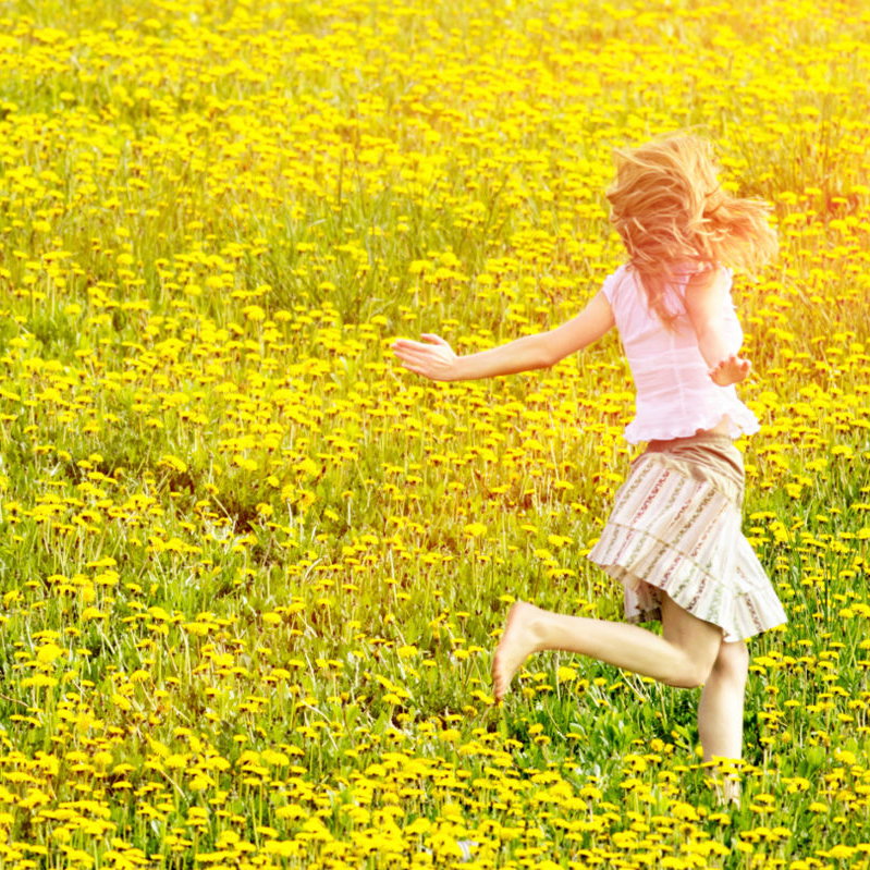 Junge Frau läuft auf Blumenwiese